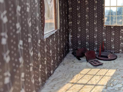 Broken table and chairs in a room in an abandoned (doll) house