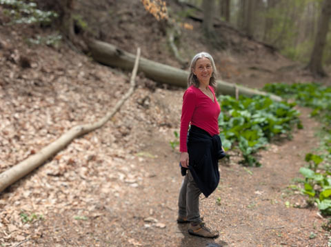 My wife Mary, standing on a trail in the woods, looking beautiful
