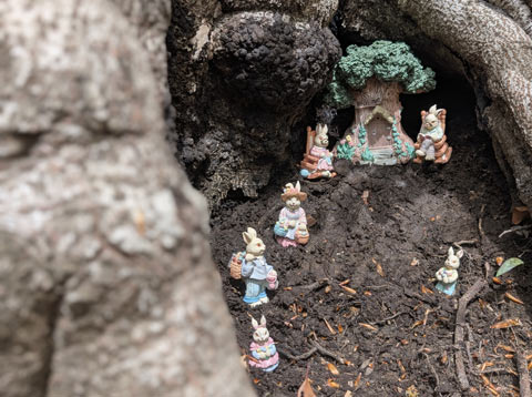 A tableau of the Easter Bunny and his family realaxing in front of their home, which apparently is a tree house