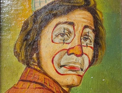 A close up of an oil painting of a sad looking clown's face